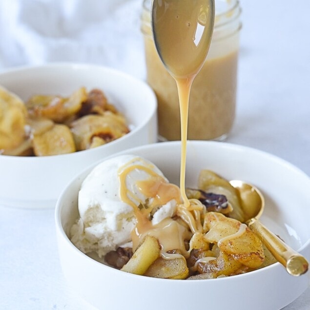 spooning dulce de leche on apples