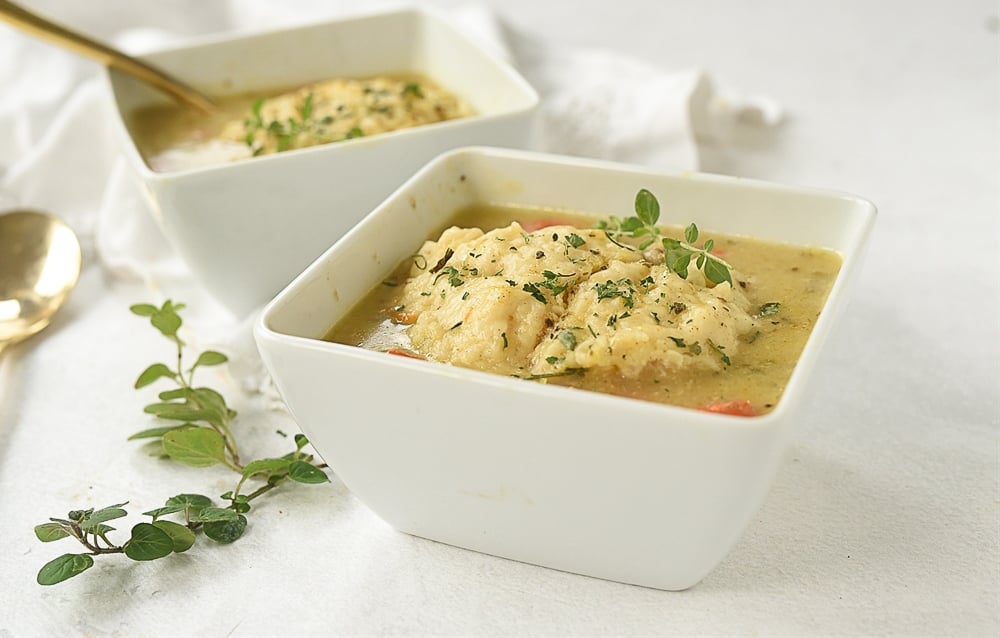 white bowl of chicken and dumplings