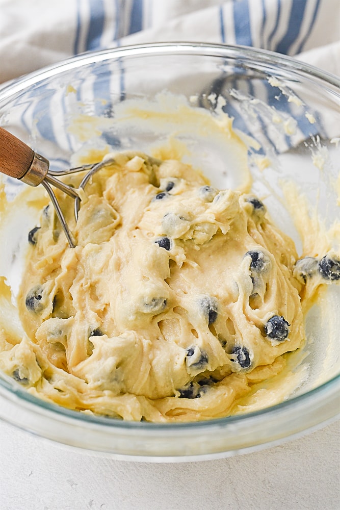 stirring blueberry muffin batter