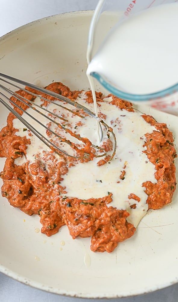 adding cream to roasted red peppers