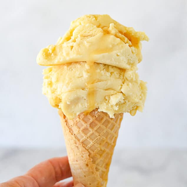 hand holding a maple ice cream cone