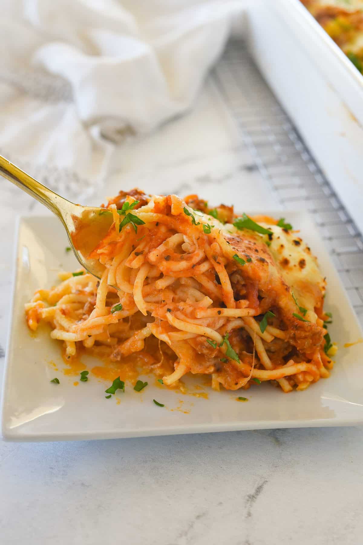 fork full of baked spaghetti
