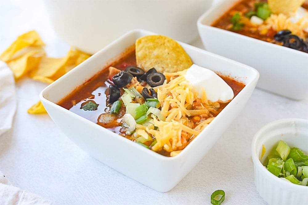 bowl of chicken tortilla soup with cheese on top