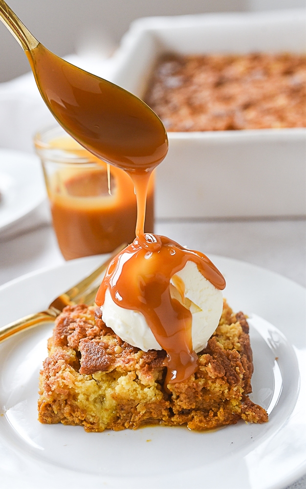 pouring caramel over pumpkin dump cake