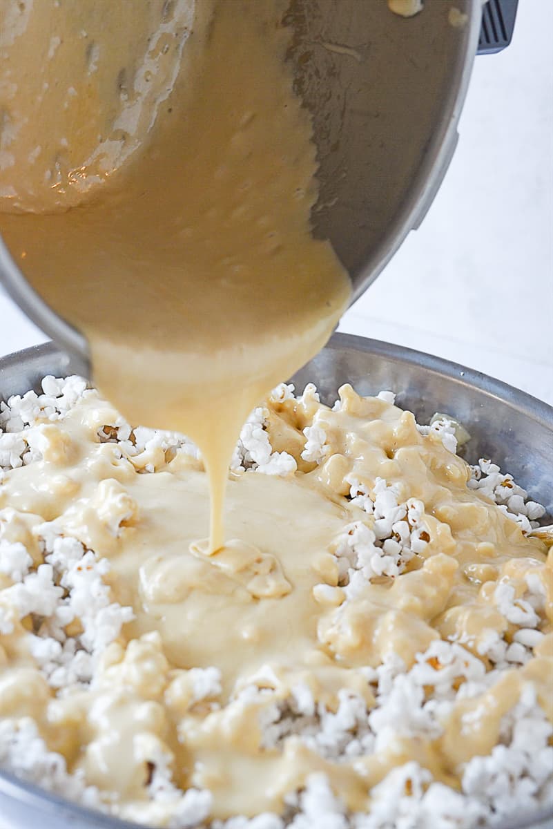 pouring marshmallow over popcorn