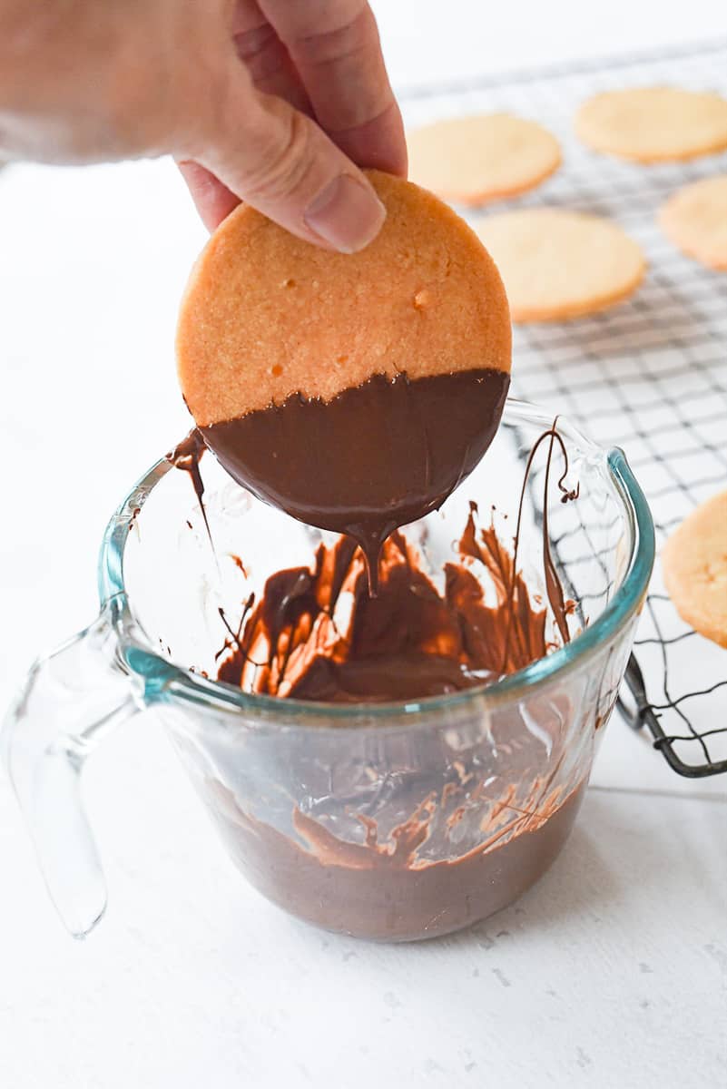 dipping shortbread in chocolate.