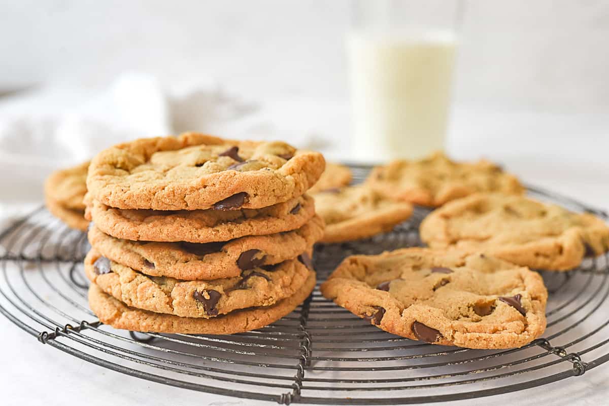 stack of peanut butter cookies with a glass of milk