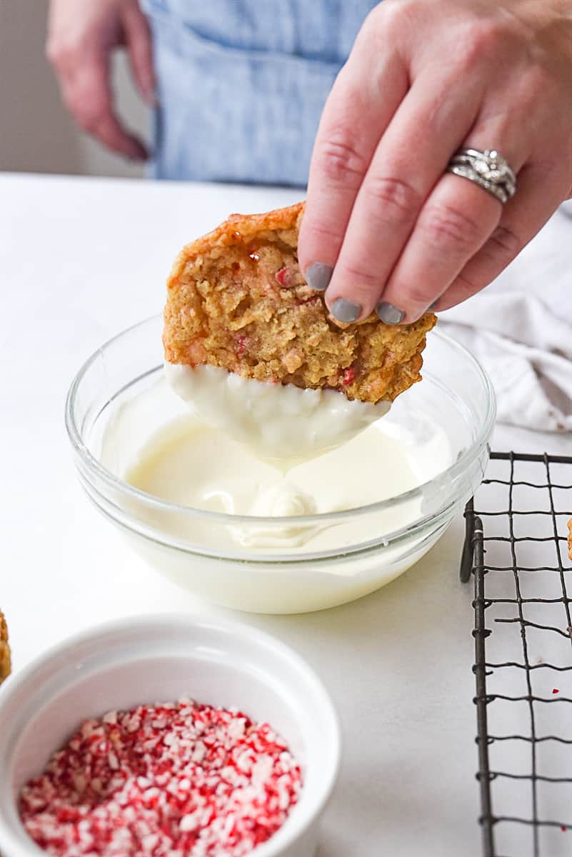 dipping oatmeal cookie in white chocolate