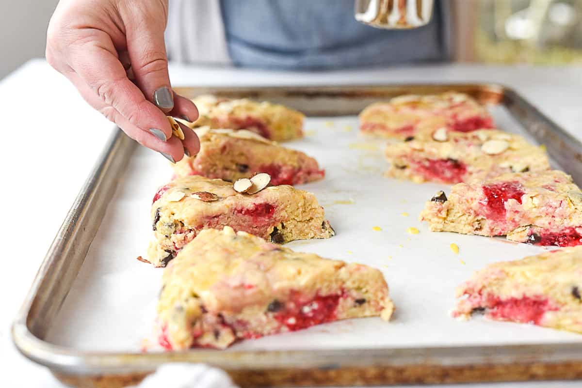 sprinkling almonds on scones