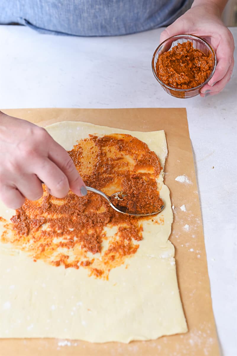 spreading filling on palmier dough