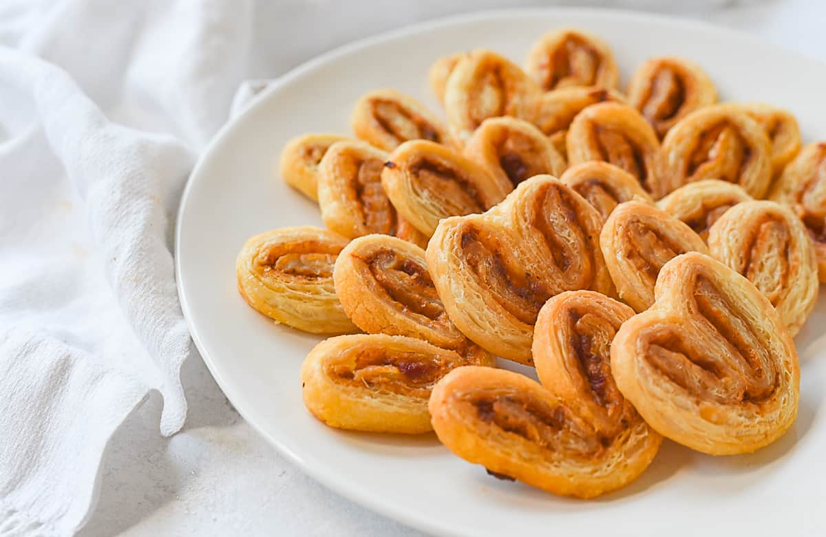 savory palmiers on a plate.