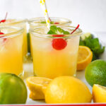 glasses of sparkling orange lemonade with a cherry