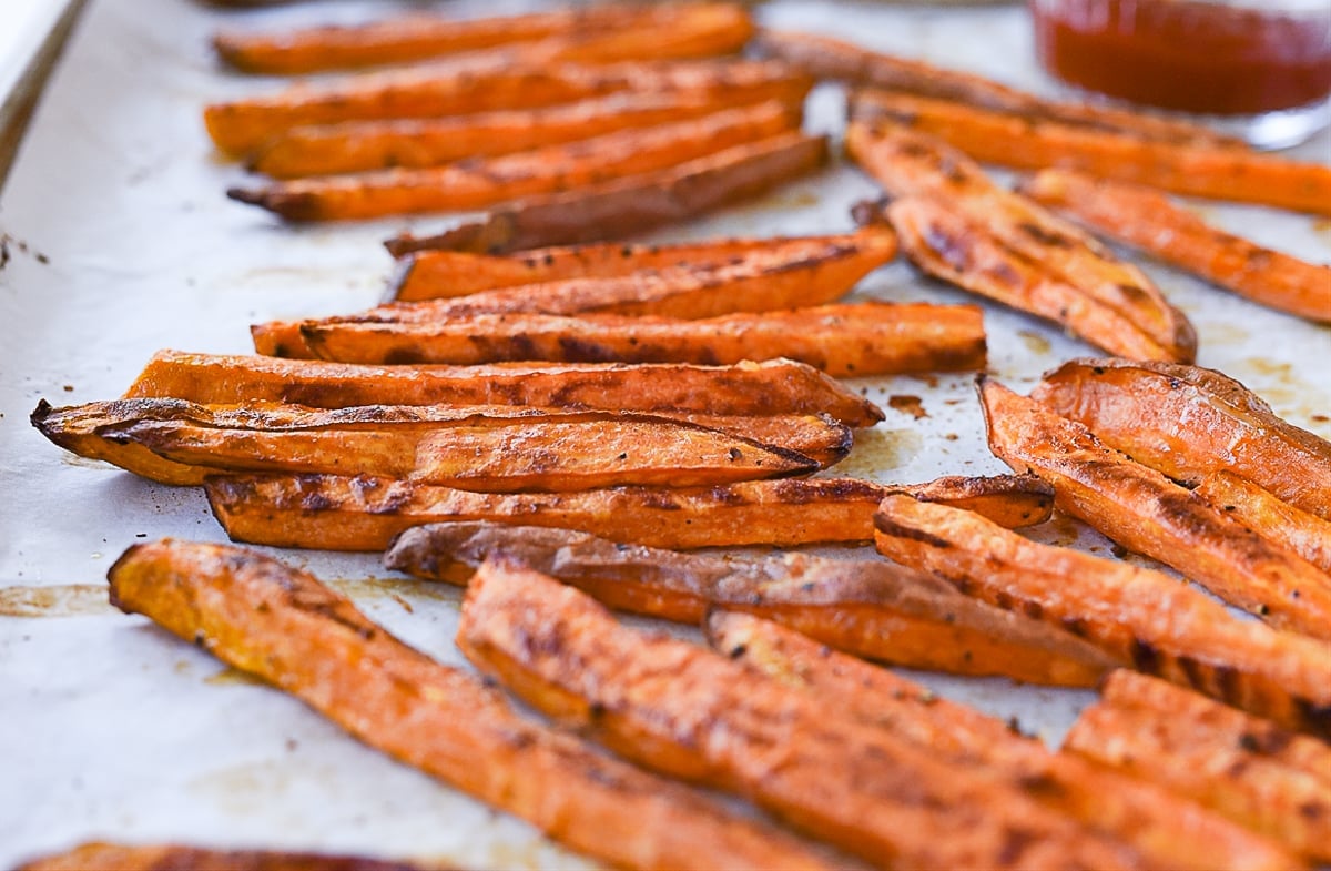 baked sweet potato fries on a baking sheet