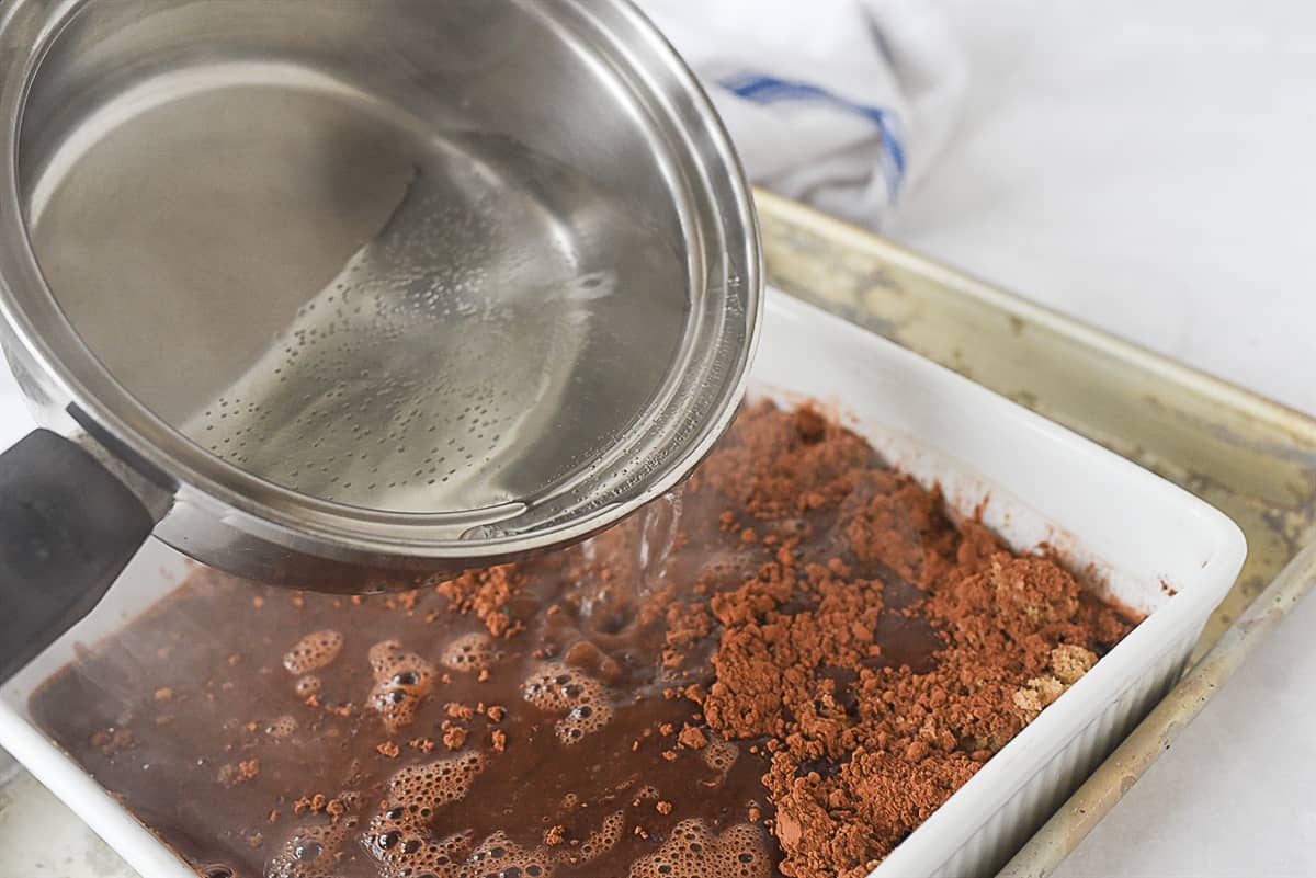 pouring hot water over hot fudge cake batter