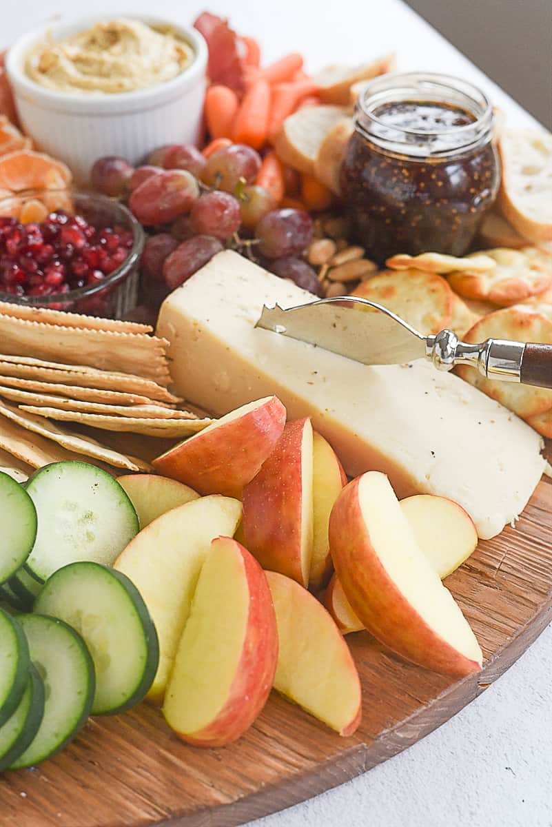 sliced apples and cucumbers on cheeses board