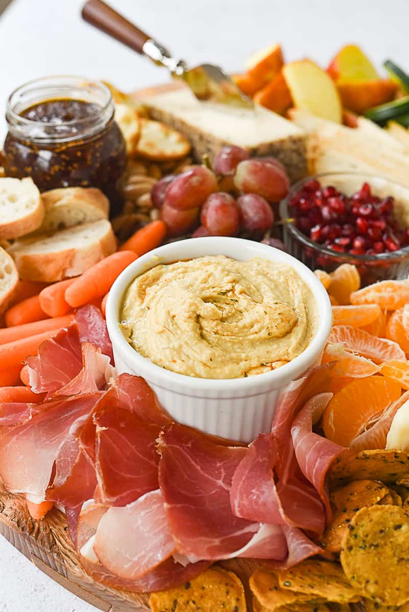 bowl of hummus on cheeseboard