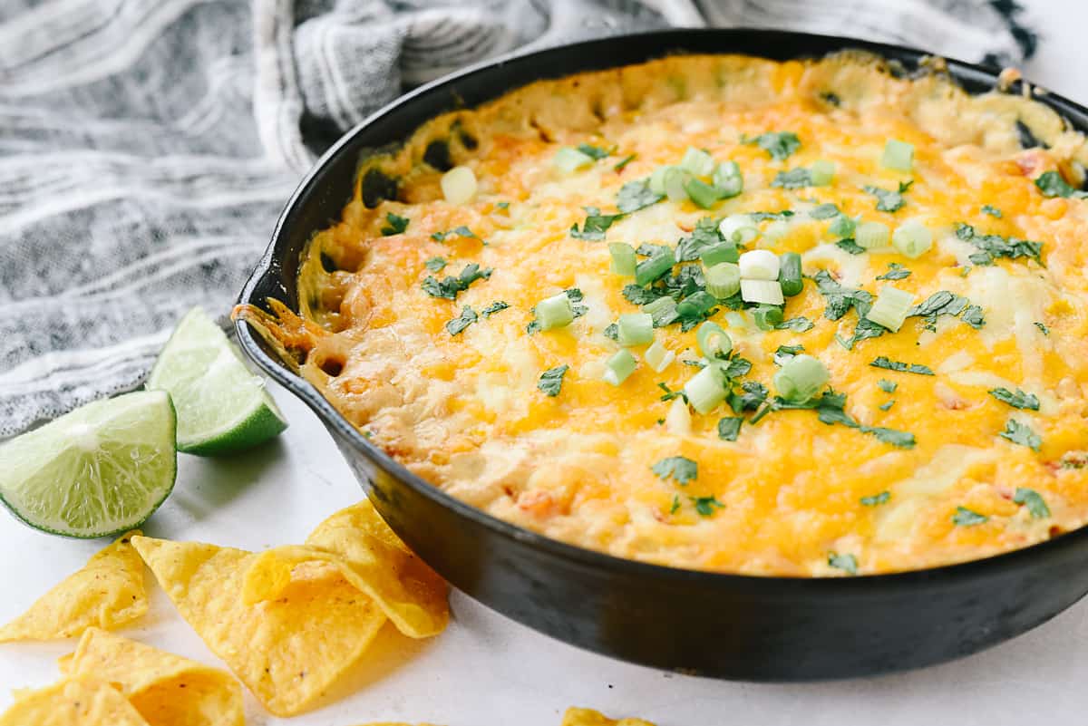 cream cheese corn dip with green onions on top.