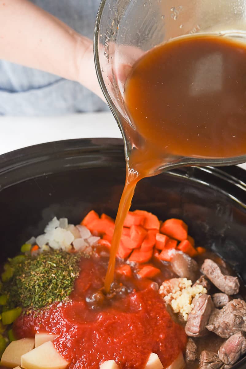 pouring broth into corck pot.