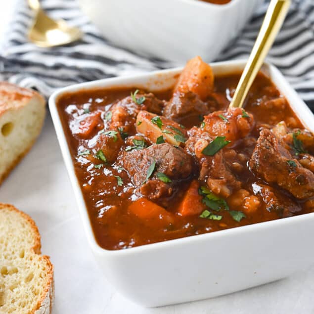 white bowls of beef soup