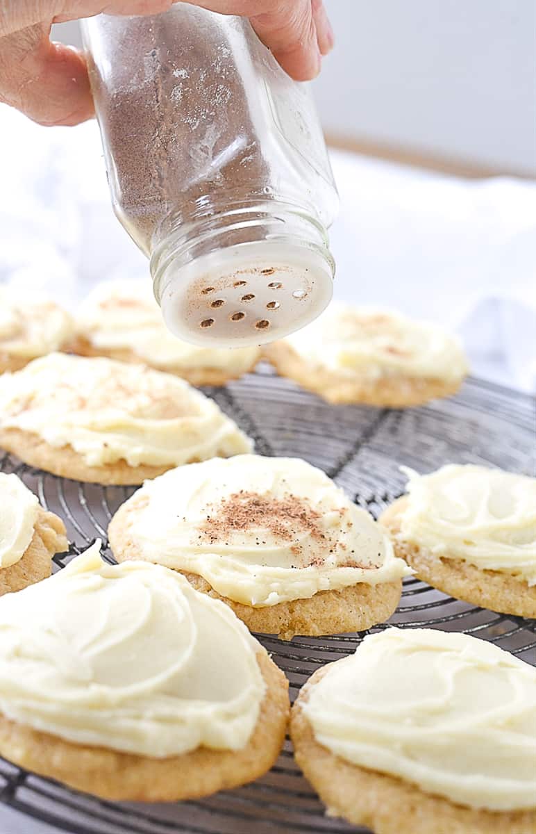 sprinkling nutmeg on cookies