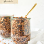 two jars of granola with a spoon in it