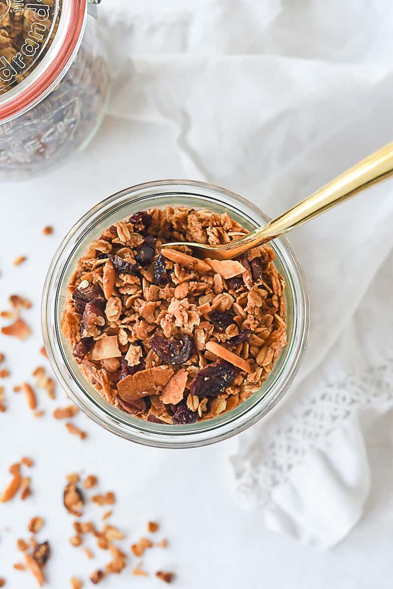 open jar of granola with spoon in it