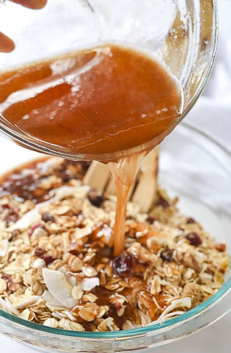 pouring syrup into granola ingredients