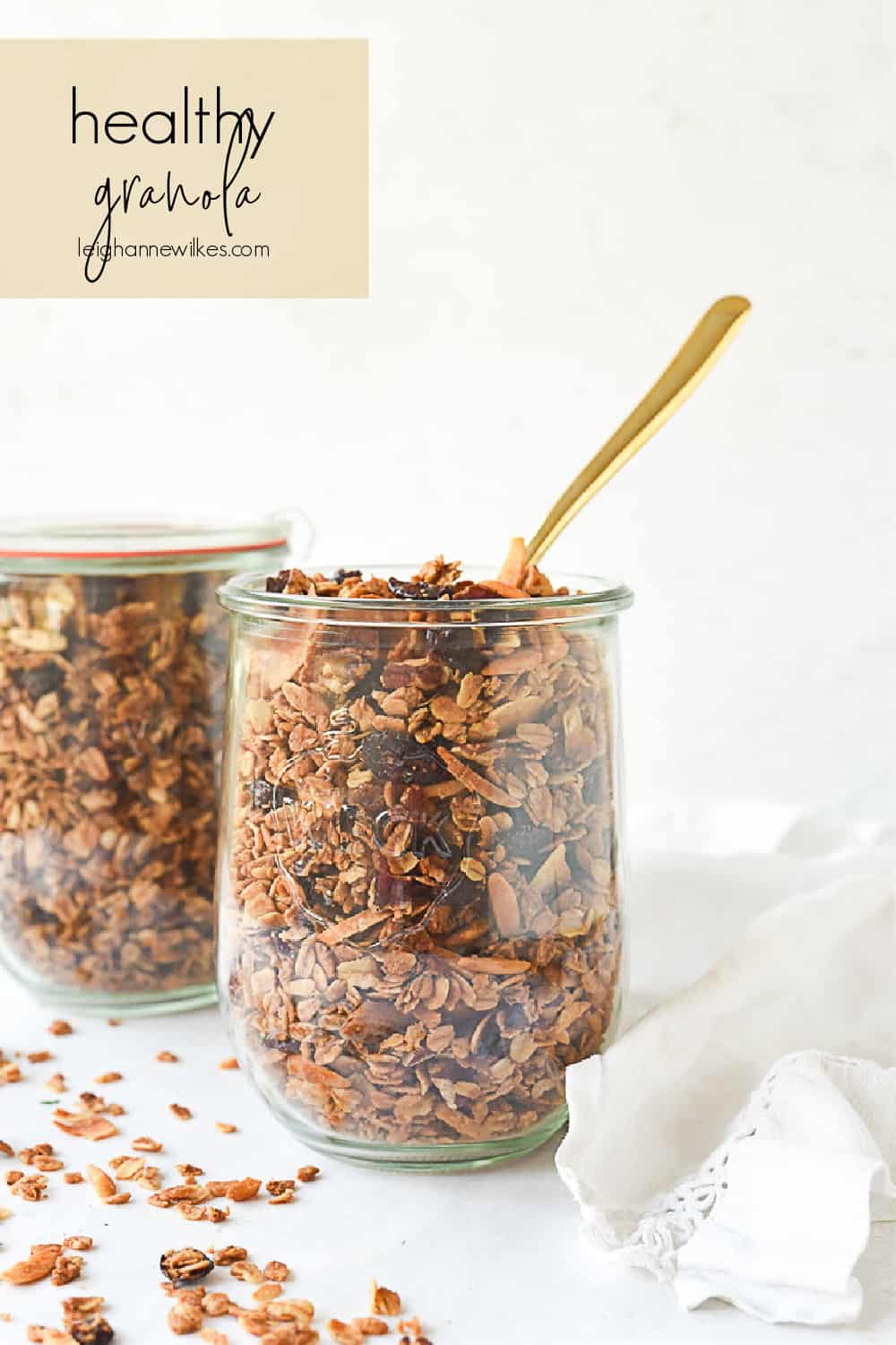 two jars of granola with a spoon in it