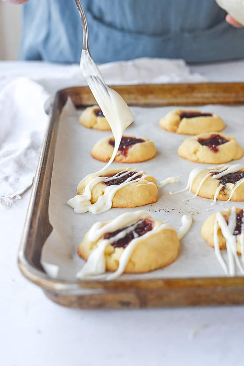 drizzling glaze on shortbread cookies