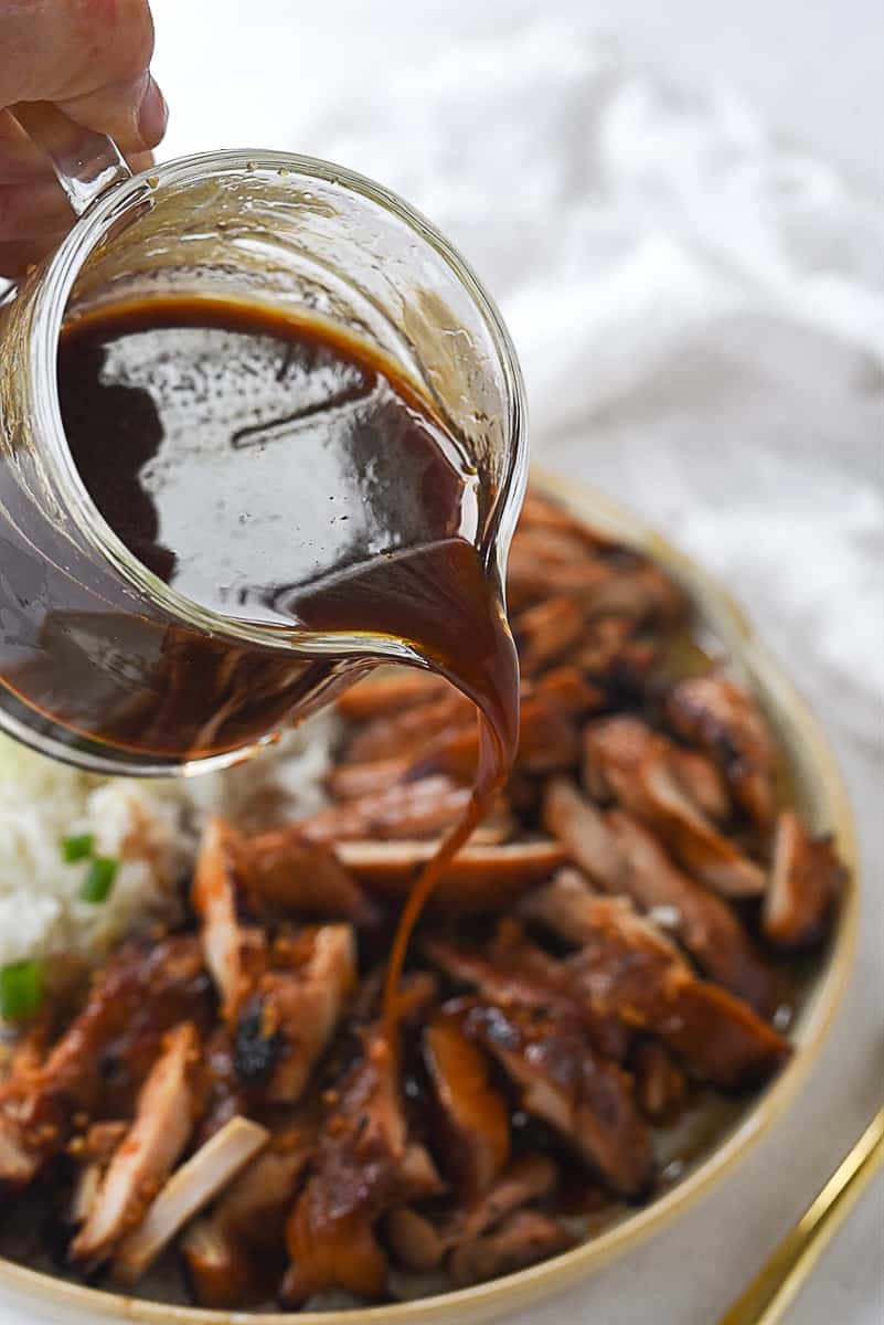 pouring teriyaki over chicken