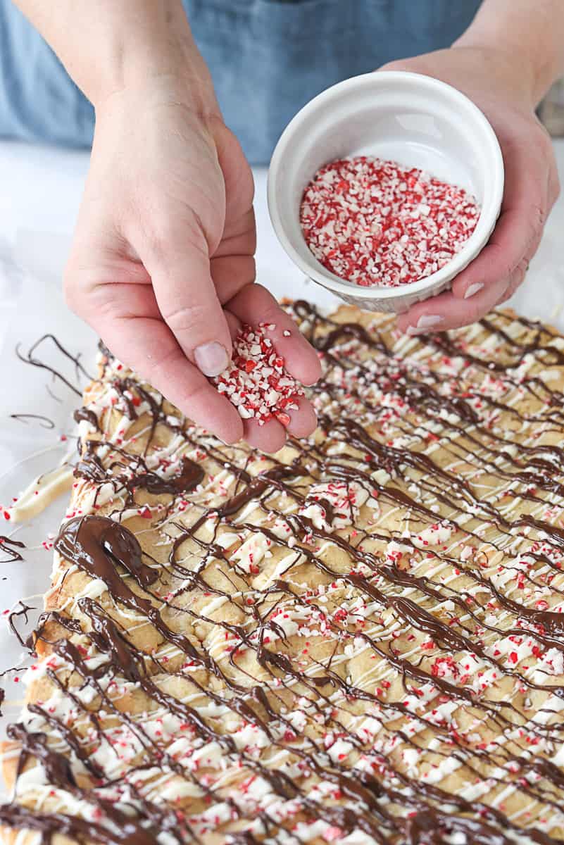 sprinkling candy cane on blondies