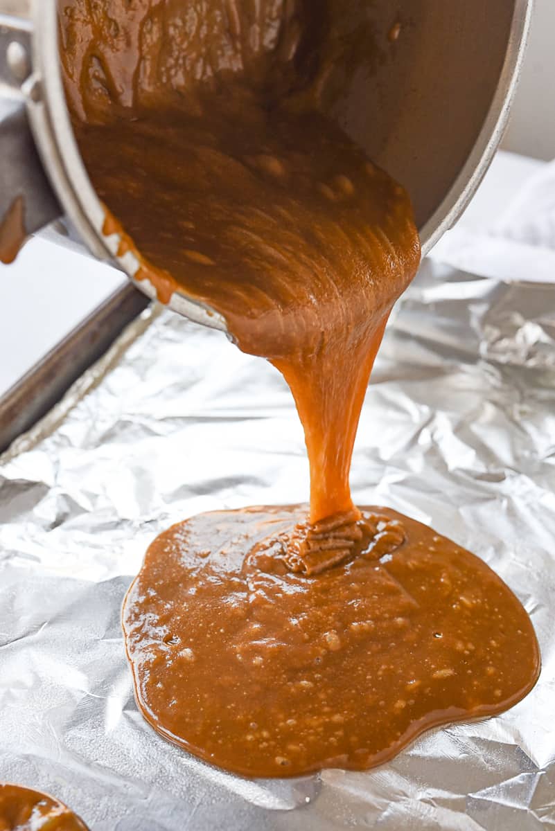 pouring toffee onto baking sheet