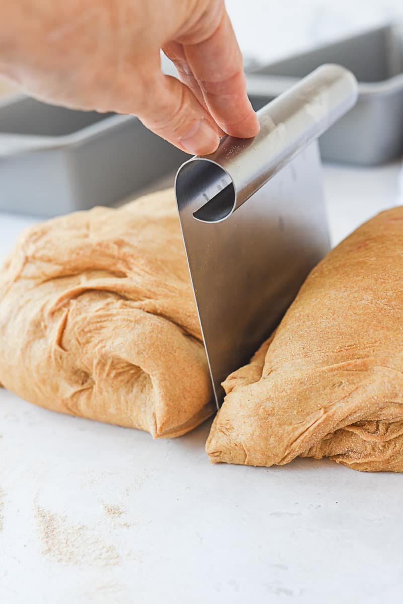 cutting wheat bread dough in half