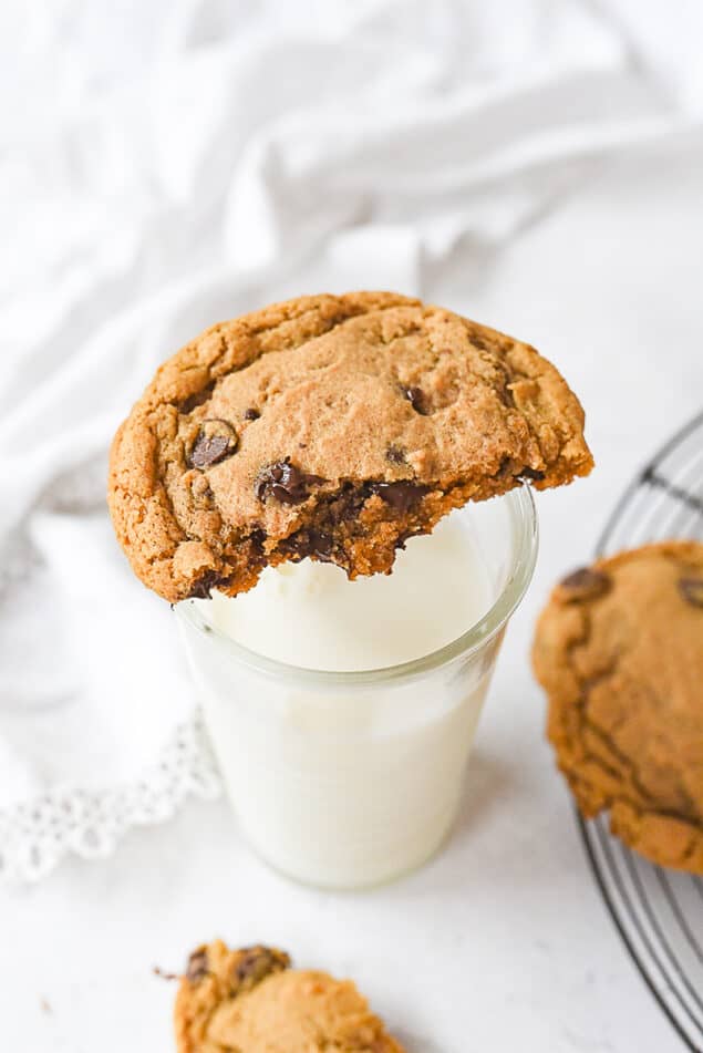 chocolate chip cookie on a class of milk