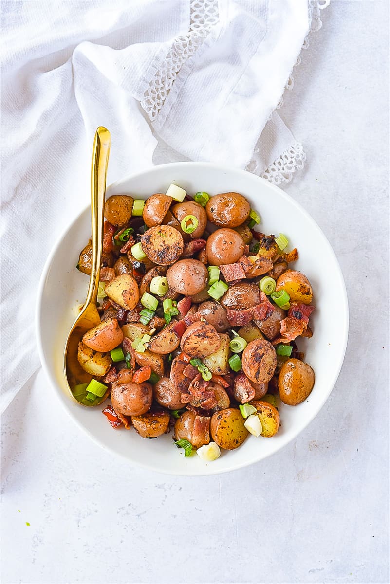 bowl of breakfast potatoes with spoon in it