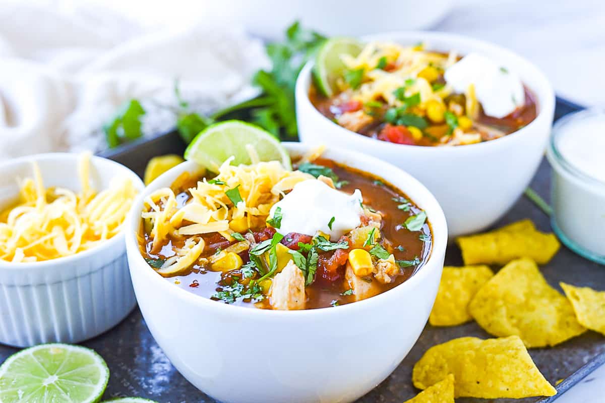 chicken torilla soup in white bowls