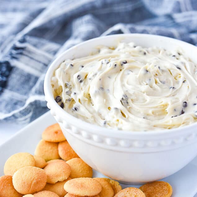 bowl of chocolate chip cookie dough dip and cookies on a plate