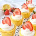 rows of lemon cupcakes with strawberries on top