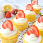 rows of lemon cupcakes with strawberries on top