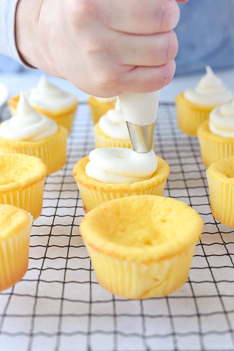 Frosting a lemon cupcake