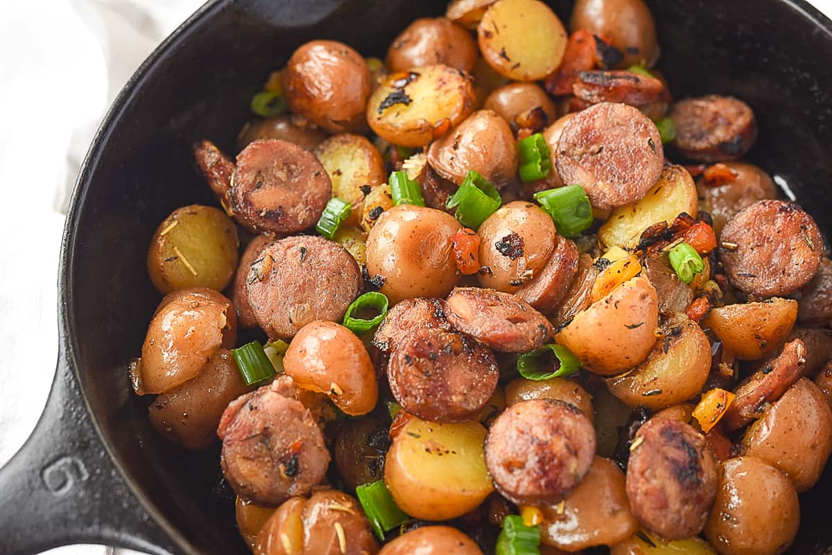 Skillet potatoes in a cast iron pan with green onions.