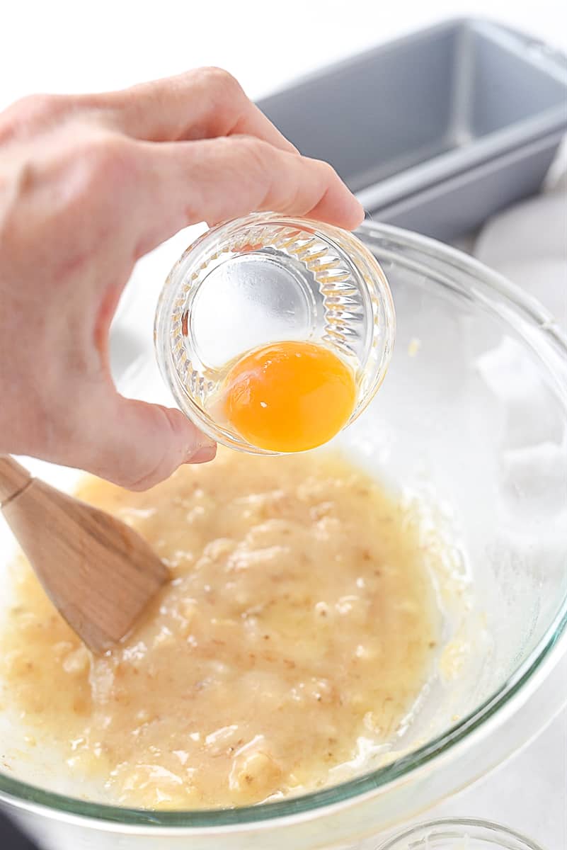 adding egg yolk to banana bread.