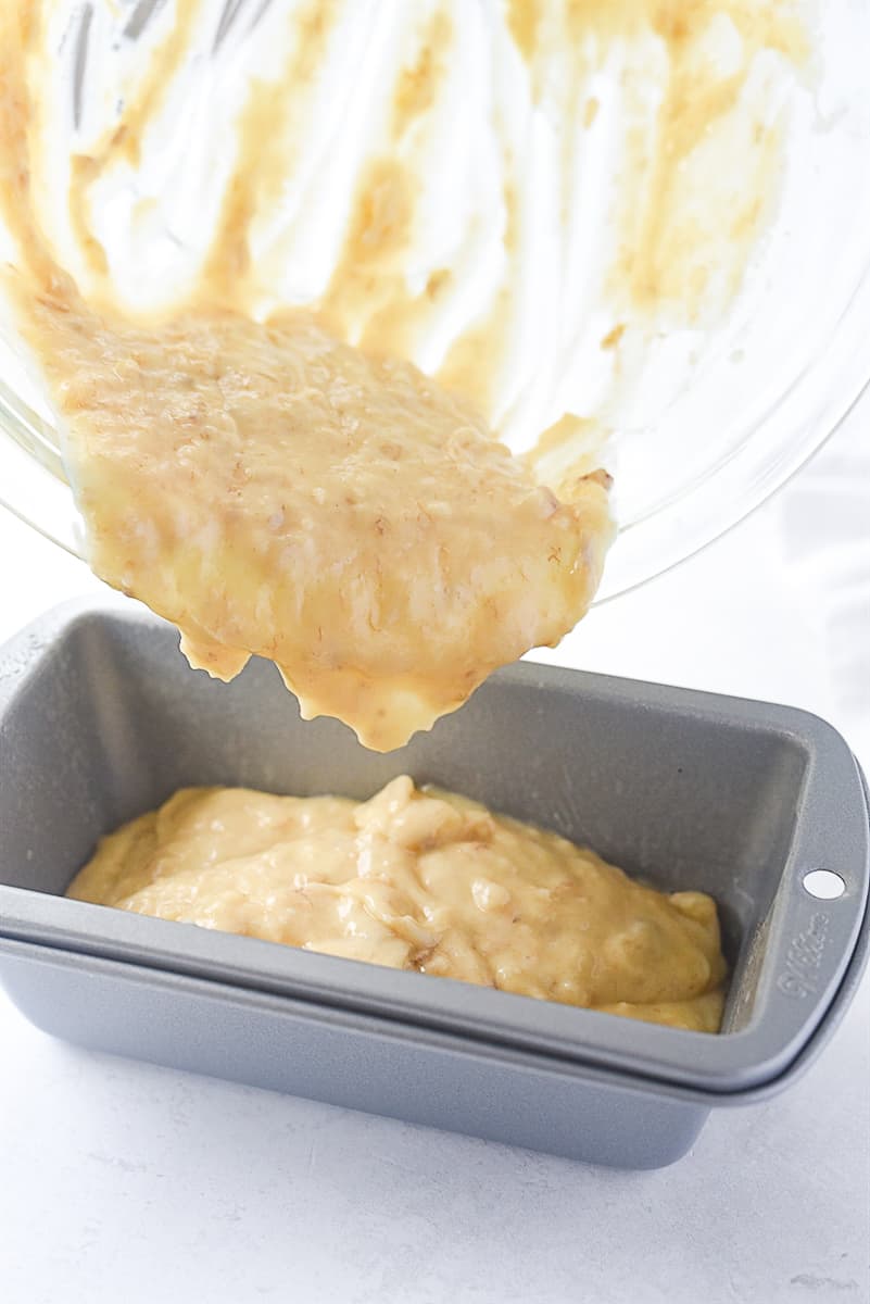 pouring banana bread  batter into pan