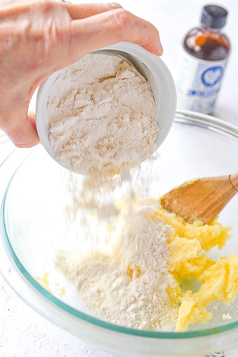 adding flour to cookie dough.