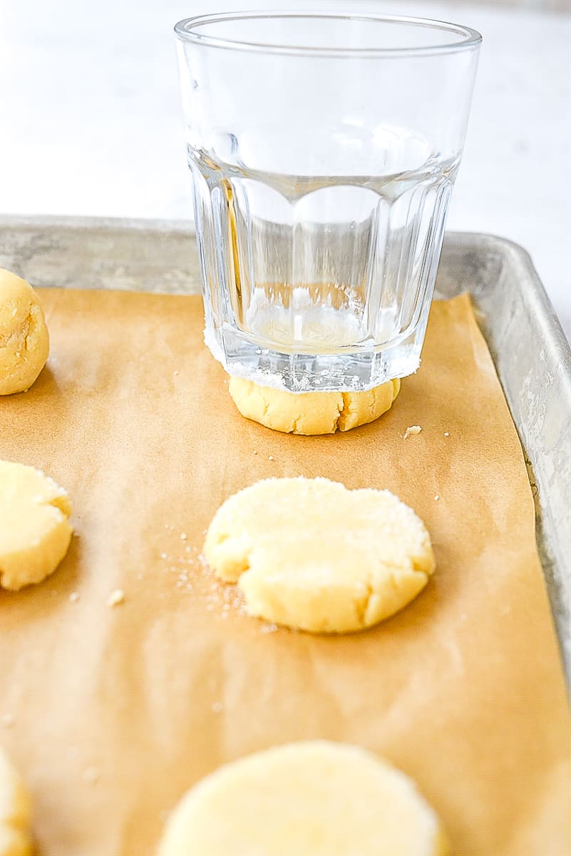 flattening sugar cookie dough with glass