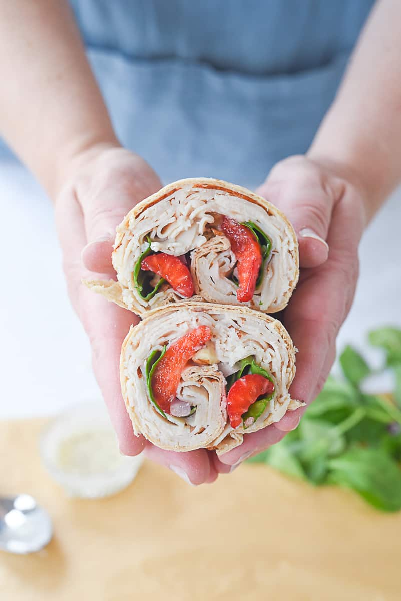strawberry turkey wrap hands holding. turkey wrap