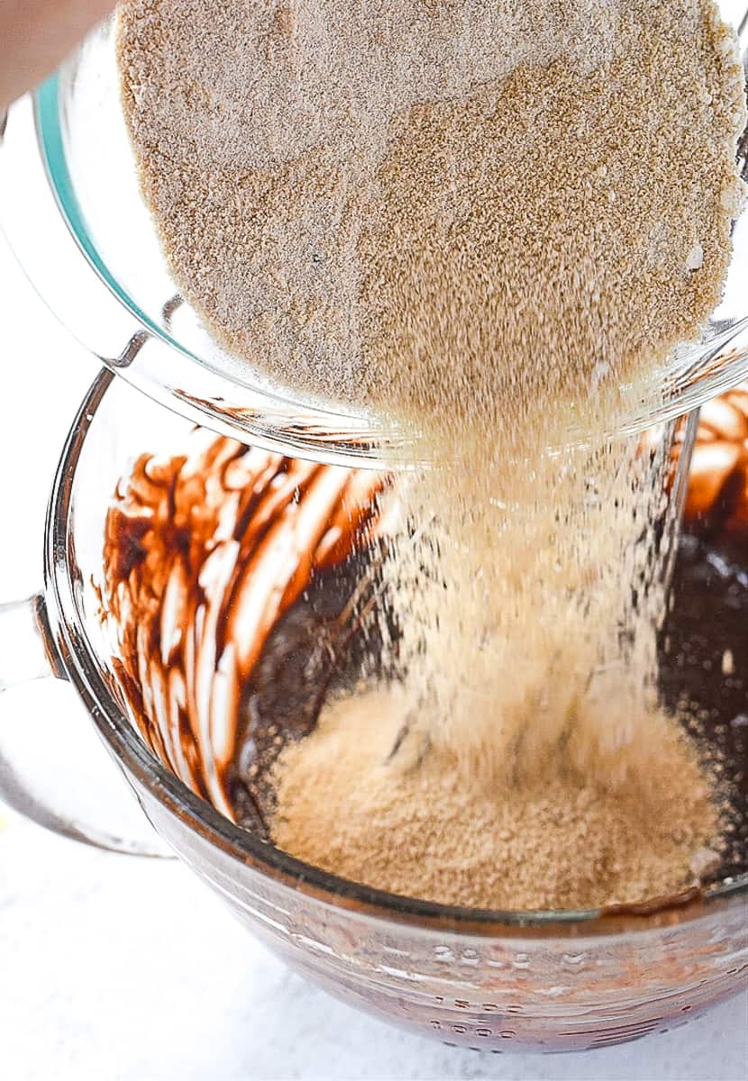 pouring flour mixture into chocolate 