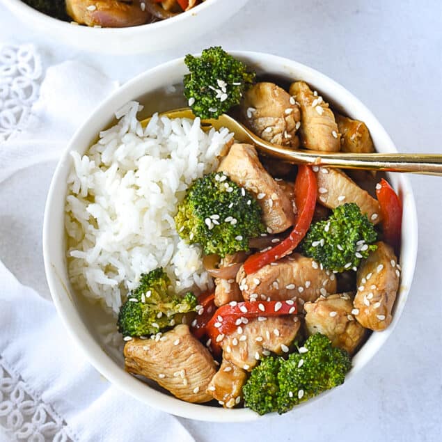 Red Pepper and CHicken Stir Fry in a bowl over rice