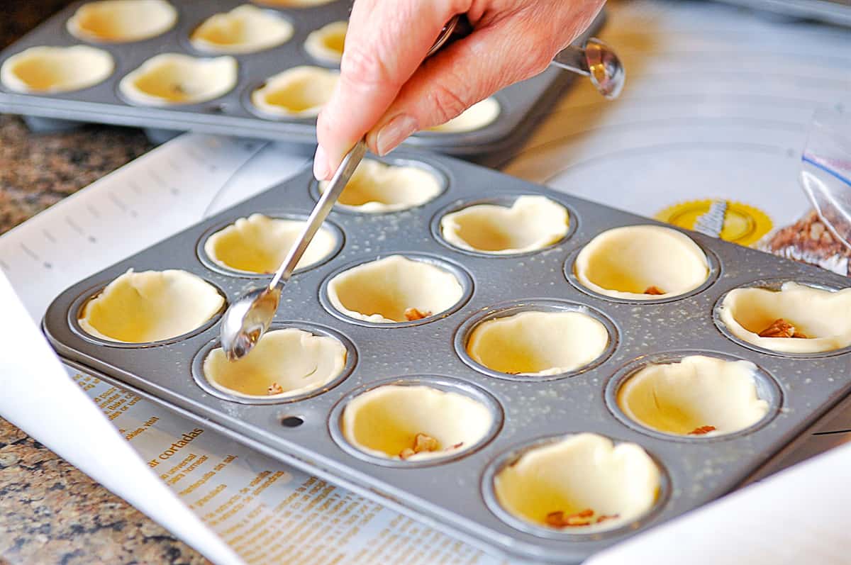 adding nuts to muffin tin