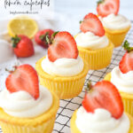 rows of lemon cupcakes with strawberries on top